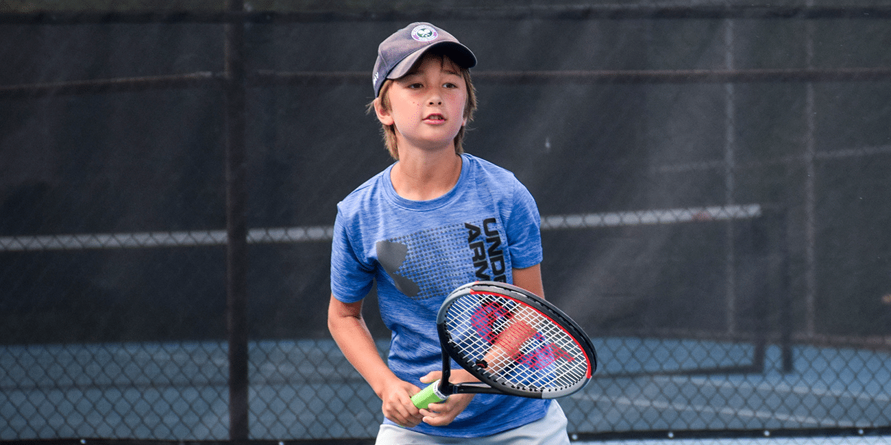 UTA (Universal Tennis Academy)Piedmont Park Junior Programs Boy Returning Ball